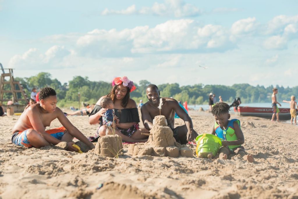 family building sand castles at the beach