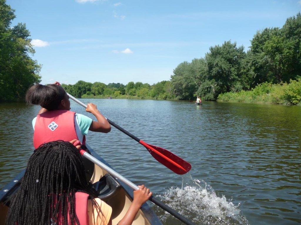 two women kayaking on river